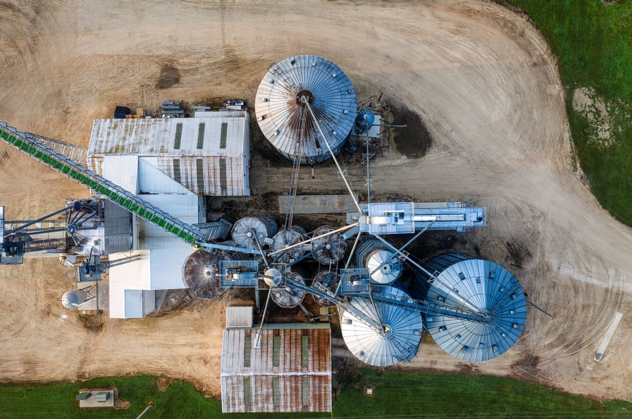 Drone shot capturing the top view of industrial silos and buildings in Utica, MN.
